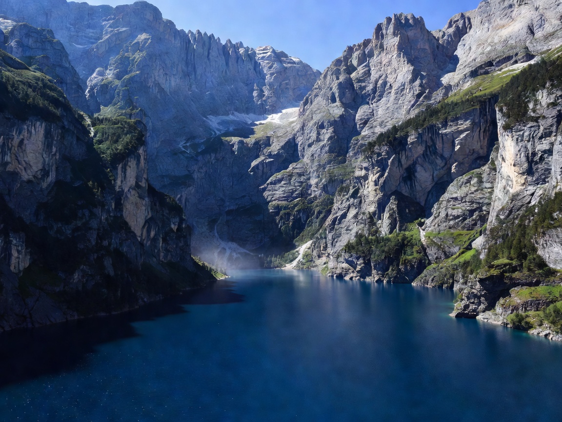 Deep blue alpine lake Oeschinensee surrounded by steep vertical cliffs
